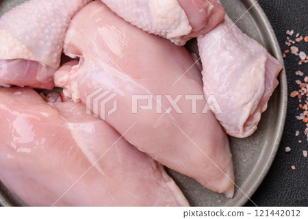 Pieces of raw chicken or turkey fillet with salt, spices and herbs 121442012