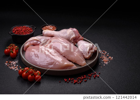 Pieces of raw chicken or turkey fillet with salt, spices and herbs 121442014