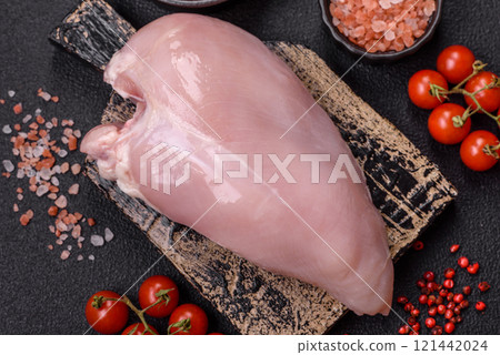 Pieces of raw chicken or turkey fillet with salt, spices and herbs 121442024