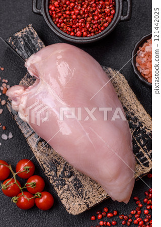 Pieces of raw chicken or turkey fillet with salt, spices and herbs 121442025