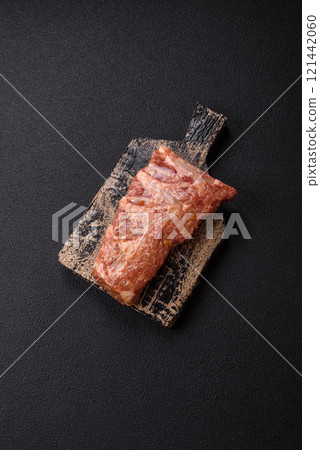 Pork ribs in sweet and sour sauce with salt and spices Pork ribs in sweet and sour sauce with salt and spices 121442060
