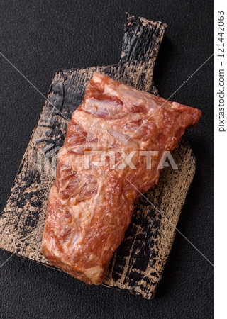 Pork ribs in sweet and sour sauce with salt and spices 121442063