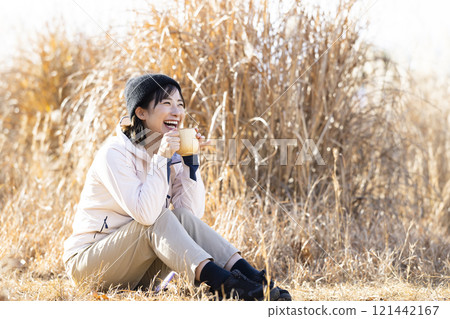 A woman drinking hot coffee A woman drinking hot coffee 121442167