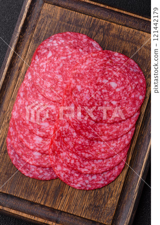 Delicious smoked salami sausage with salt, spices and herbs 121442179