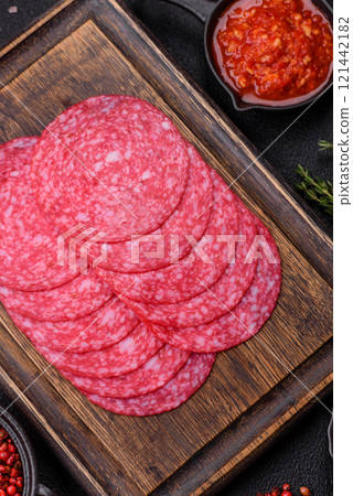 Delicious smoked salami sausage with salt, spices and herbs 121442182