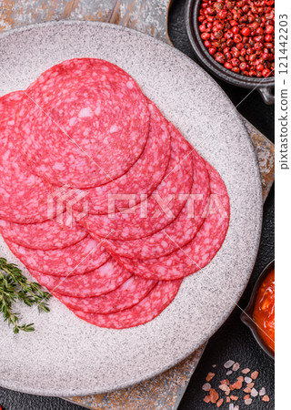 Delicious smoked salami sausage with salt, spices and herbs Delicious smoked salami sausage with salt, spices and herbs 121442203