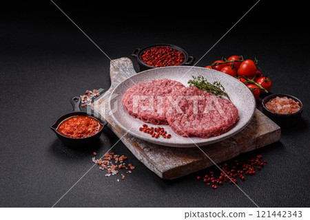 Fresh raw ground beef burger patty with salt and spices 121442343