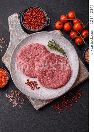 Fresh raw ground beef burger patty with salt and spices Fresh raw ground beef burger patty with salt and spices 121442345