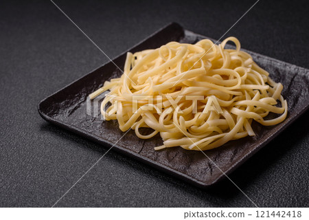 Rice noodles with beans, meat, tomato sauce, spices and herbs 121442418