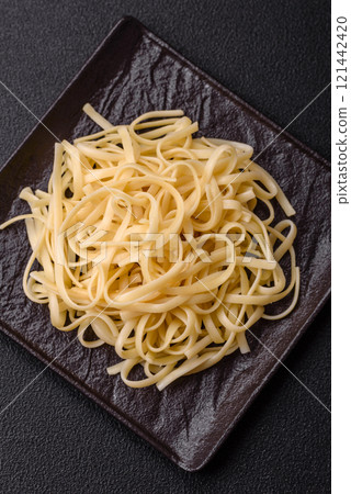 Rice noodles with beans, meat, tomato sauce, spices and herbs 121442420