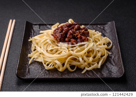 Rice noodles with beans, meat, tomato sauce, spices and herbs 121442429