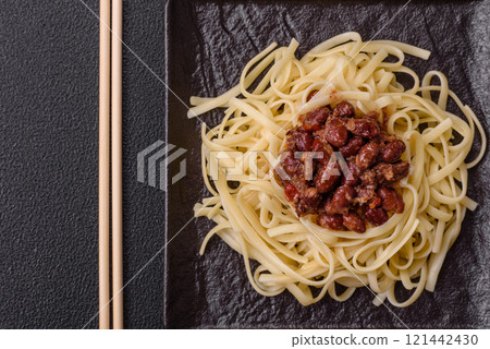 Rice noodles with beans, meat, tomato sauce, spices and herbs Rice noodles with beans, meat, tomato sauce, spices and herbs 121442430