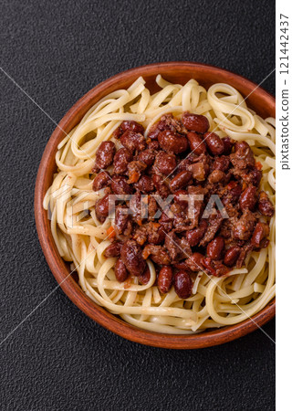 Rice noodles with beans, meat, tomato sauce, spices and herbs Rice noodles with beans, meat, tomato sauce, spices and herbs 121442437