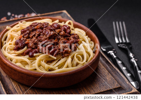 Rice noodles with beans, meat, tomato sauce, spices and herbs Rice noodles with beans, meat, tomato sauce, spices and herbs 121442438