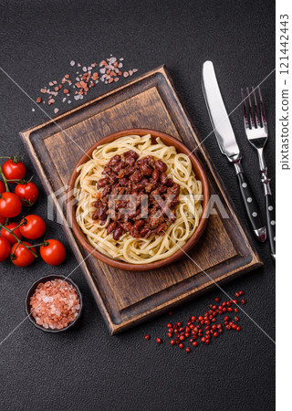 Rice noodles with beans, meat, tomato sauce, spices and herbs 121442443