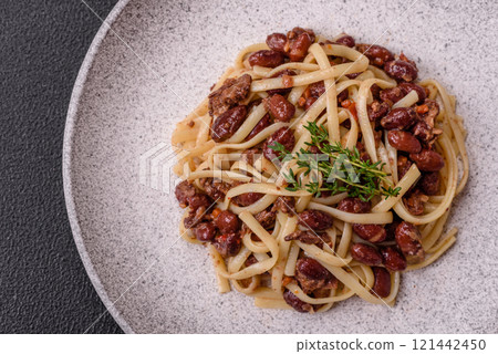 Rice noodles with beans, meat, tomato sauce, spices and herbs Rice noodles with beans, meat, tomato sauce, spices and herbs 121442450