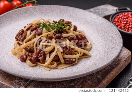 Rice noodles with beans, meat, tomato sauce, spices and herbs Rice noodles with beans, meat, tomato sauce, spices and herbs 121442452