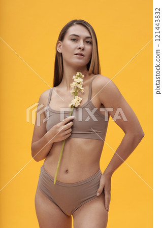 Slim Girl Posing With Flower 121443832