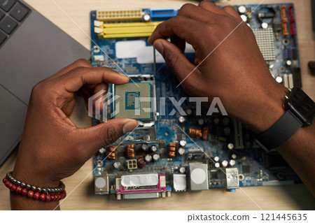 Repairman Setting Chip In Motherboard 121445635