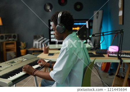 Musician Playing Piano In Studio 121445694