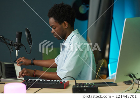 Composer Playing Synthesizer In Recording Studio 121445701