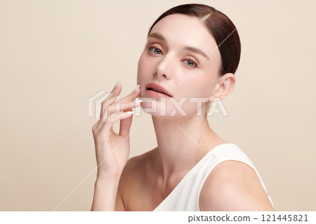 Beautiful young woman with clean fresh skin on beige background, Face care, Facial treatment, Cosmetology, beauty and spa, women portrait. 121445821