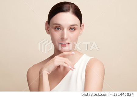 Beautiful young woman with clean fresh skin on beige background, Face care, Facial treatment, Cosmetology, beauty and spa, women portrait. 121445824