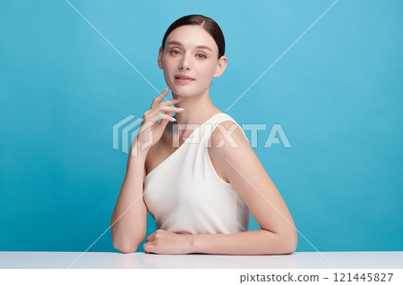 Beautiful young woman with clean fresh skin on blue background, Face care, Facial treatment, Cosmetology, beauty and spa, women portrait. 121445827