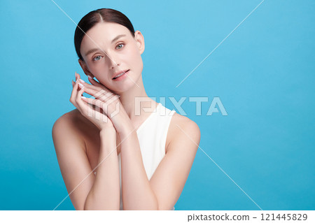 Beautiful young woman with clean fresh skin on blue background, Face care, Facial treatment, Cosmetology, beauty and spa, women portrait. 121445829