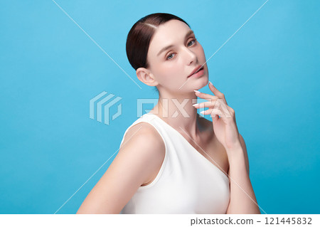 Beautiful young woman with clean fresh skin on blue background, Face care, Facial treatment, Cosmetology, beauty and spa, women portrait. 121445832