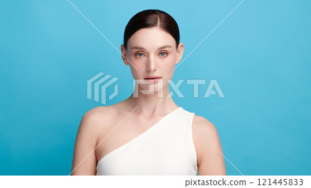 Beautiful young woman with clean fresh skin on blue background, Face care, Facial treatment, Cosmetology, beauty and spa, women portrait. Beautiful young woman with clean fresh skin on blue background, Face care, Facial treatment, Cosmetology, beauty and spa, women portrait. 121445833