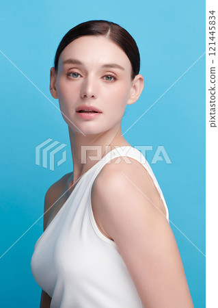 Beautiful young woman with clean fresh skin on blue background, Face care, Facial treatment, Cosmetology, beauty and spa, women portrait. Beautiful young woman with clean fresh skin on blue background, Face care, Facial treatment, Cosmetology, beauty and spa, women portrait. 121445834