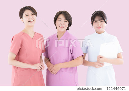 Three nurses lined up looking at the camera, image background pink Three nurses lined up looking at the camera, image background pink 121446071