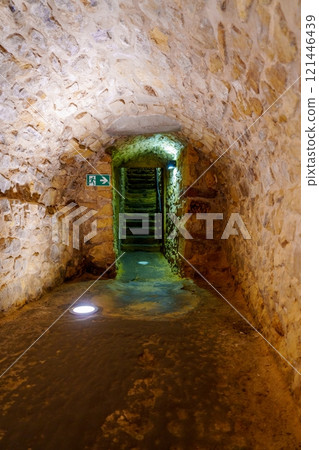 Illuminated historic underground passage with stone steps in the old town of Luxembourg-city 121446439
