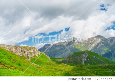 Picturesque Mountain Landscape Of Kaprun, Austria With Lush Green Pastures And Cloudy Sky Picturesque Mountain Landscape Of Kaprun, Austria With Lush Green Pastures And Cloudy Sky 121446466