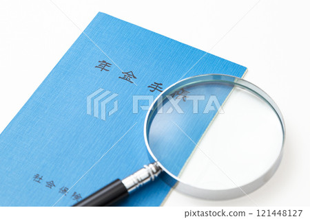 Pension book and magnifying glass on white background Pension book and magnifying glass on white background 121448127