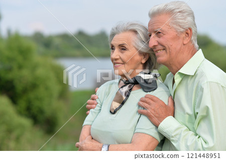 Loving mature couple in the park in summer Loving mature couple in the park in summer 121448951