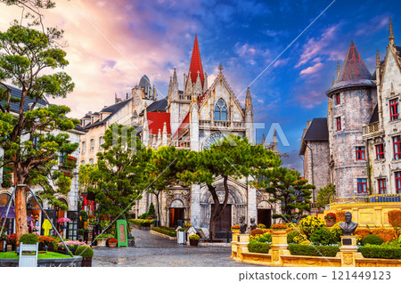 Catholic church on the square in French village in Ba Na Hills Park in Da Nang in Vietnam at sunset Catholic church on the square in French village in Ba Na Hills Park in Da Nang in Vietnam at sunset 121449123