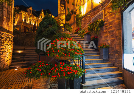 Summer potted flowers decorating the steps and walls and houses in the evening 121449131