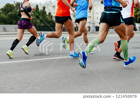 group men and woman running marathon together in city group men and woman running marathon together in city 121450079