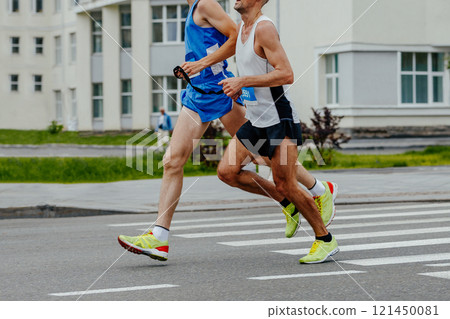 blind runner with his guide running city marathon 121450081