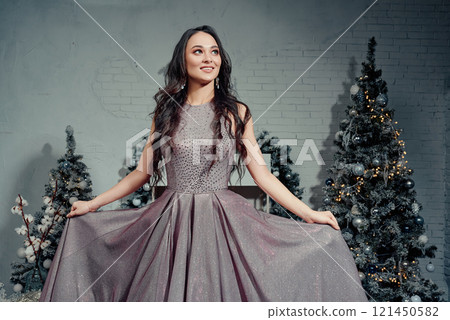Elegant Woman Glowing in Festive Sparkle. Elegant Woman Glowing in Festive Sparkle. 121450582