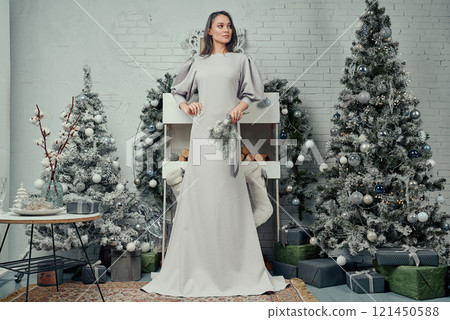 Elegant Woman in a Winter Wonderland Scene. 121450588