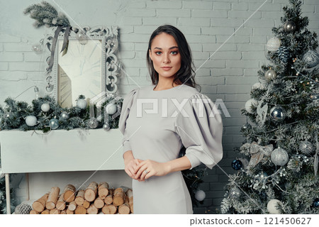 Sophisticated Woman by Christmas Tree. Sophisticated Woman by Christmas Tree. 121450627