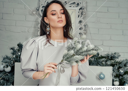 Elegant Woman Holding Frosted Greenery Bouquet. Elegant Woman Holding Frosted Greenery Bouquet. 121450630