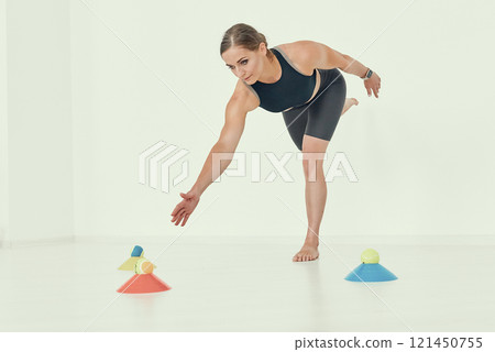 Balance and Coordination Exercise by Fitness Trainer. 121450755