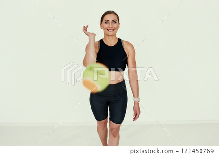 Fitness Trainer Tossing Tennis Ball. Fitness Trainer Tossing Tennis Ball. 121450769