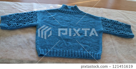 Hand-knitted sweater, Aran pattern, knitting with needles Hand-knitted sweater, Aran pattern, knitting with needles 121451619