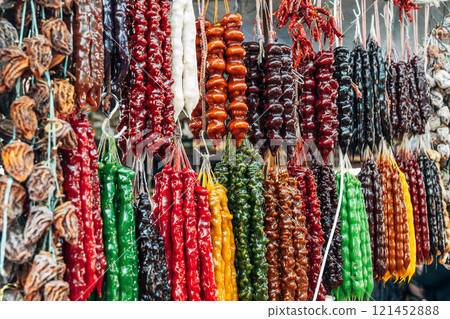 Churchkhela made from nuts hangs at a local market. 121452888