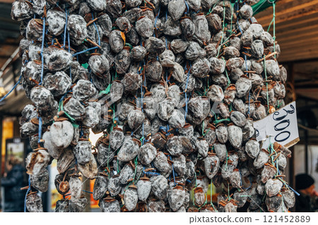 Dried persimmon fruits are sold at the market 121452889